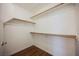 Walk-in closet with white walls and wooden shelving at 430 Nancy Dr, Henderson, NV 89015