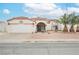 Charming single-story home featuring a landscaped front yard and a two-car garage at 430 Nancy Dr, Henderson, NV 89015