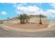 Landscaped front yard with desert landscaping and palm trees surrounding the home at 430 Nancy Dr, Henderson, NV 89015