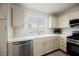 Kitchen featuring a stainless steel dishwasher, gas range and white cabinetry at 430 Nancy Dr, Henderson, NV 89015