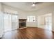 Inviting living room features a stone fireplace, ceiling fan, and sliding door with sheer curtains at 430 Nancy Dr, Henderson, NV 89015