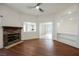 Open-concept living room features wood floors, a stone fireplace, and views of the kitchen at 430 Nancy Dr, Henderson, NV 89015