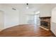 Bright living room featuring stone fireplace, hardwood flooring, and large window at 430 Nancy Dr, Henderson, NV 89015