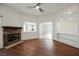 Bright living room with hardwood floors, stone fireplace, and open access to other rooms at 430 Nancy Dr, Henderson, NV 89015
