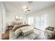 Staged main bedroom featuring a ceiling fan, sliding glass door, and modern furnishings at 430 Nancy Dr, Henderson, NV 89015