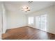 Bright main bedroom featuring hardwood floors, sliding glass door and ceiling fan at 430 Nancy Dr, Henderson, NV 89015