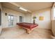 Covered patio with concrete floors featuring a pool table and exterior access at 430 Nancy Dr, Henderson, NV 89015