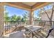 Inviting outdoor balcony featuring a table and chairs, perfect for enjoying scenic views and relaxing outdoors at 4630 Basilicata Ln # 203, North Las Vegas, NV 89084