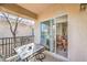 Comfortable balcony with table and chairs, conveniently accessible from the dining area through sliding glass doors at 4630 Basilicata Ln # 203, North Las Vegas, NV 89084