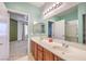 Open bathroom into main bedroom with double sinks and modern fixtures at 4630 Basilicata Ln # 203, North Las Vegas, NV 89084