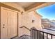 Exterior entrance with light-colored door, overhead light fixture, and view of the neighborhood at 4630 Basilicata Ln # 203, North Las Vegas, NV 89084