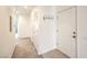 Hallway featuring neutral paint, carpet flooring, and storage closets at 4630 Basilicata Ln # 203, North Las Vegas, NV 89084