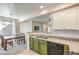 Eat-in kitchen features sleek countertops, green cabinets, and stainless steel dishwasher at 4630 Basilicata Ln # 203, North Las Vegas, NV 89084