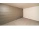 Angle view of the carpeted basement with custom accent wall and neutral color palette at 4941 River Glen Dr # 4, Las Vegas, NV 89103