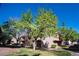 Exterior view of building featuring lush trees and landscaping at 4941 River Glen Dr # 4, Las Vegas, NV 89103