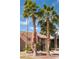 Well maintained two story building with balconies is framed by lush landscaping including mature palm trees in a desert setting at 4941 River Glen Dr # 4, Las Vegas, NV 89103