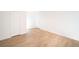 Large living room with hardwood floors and white walls at 4941 River Glen Dr # 4, Las Vegas, NV 89103