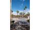 Outdoor picnic area with a grill and table nestled among palm trees at 4941 River Glen Dr # 4, Las Vegas, NV 89103
