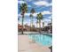 Community pool surrounded by mature palm trees and well-maintained landscaping offers an attractive amenity for residents at 4941 River Glen Dr # 4, Las Vegas, NV 89103