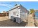 Side view of the house with partial fence and gravel filled backyard at 517 Hopi Pl, Boulder City, NV 89005