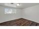 Bright bedroom with wood flooring and a large window at 517 Hopi Pl, Boulder City, NV 89005