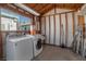 Interior laundry room area featuring washer, dryer, utility sink and window for natural light at 517 Hopi Pl, Boulder City, NV 89005