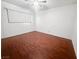 Bright bedroom features wood-look floors, ceiling fan, and a large window at 5305 Alta Dr, Las Vegas, NV 89107