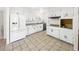 Bright kitchen featuring white cabinetry, updated appliances, tile floors and lots of natural light at 5305 Alta Dr, Las Vegas, NV 89107