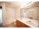 Bright bathroom featuring double sinks, large mirror, shower, and ample cabinet space at 5325 Jose Ernesto St, North Las Vegas, NV 89031