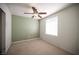 This carpeted bedroom features a ceiling fan and a window offering natural light at 5325 Jose Ernesto St, North Las Vegas, NV 89031