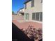 Backyard showcasing a brick patio, gravel, sliding glass door and block wall at 5773 Fresh Fields Ct, Las Vegas, NV 89118