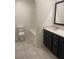 Bathroom with a dark vanity, granite countertops, and tile flooring at 5773 Fresh Fields Ct, Las Vegas, NV 89118