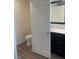 This bathroom boasts modern fixtures, a toilet and dark wood cabinets for storage and style at 5773 Fresh Fields Ct, Las Vegas, NV 89118