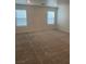 This spacious carpeted bedroom features two windows and neutral paint, creating a bright atmosphere at 5773 Fresh Fields Ct, Las Vegas, NV 89118