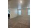 Large open bedroom area with neutral walls, and plush carpet with views into the ensuite bath at 5773 Fresh Fields Ct, Las Vegas, NV 89118