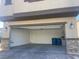 Attached garage with stone-accented exterior and ample space for parking and storage at 5773 Fresh Fields Ct, Las Vegas, NV 89118