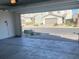 Spacious, two-car garage with an outside view of the neighborhood homes and driveways at 5773 Fresh Fields Ct, Las Vegas, NV 89118