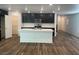Open kitchen boasts a large island, stainless appliances, and dark cabinets at 5773 Fresh Fields Ct, Las Vegas, NV 89118