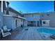 Spacious backyard featuring a wooden deck and pool, ideal for outdoor entertaining at 6171 Whispering Sands Dr, Las Vegas, NV 89131
