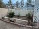 Landscaped backyard featuring garden beds, mature trees, and a brick-lined bench area at 6171 Whispering Sands Dr, Las Vegas, NV 89131