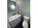 Small bathroom features updated vanity with countertop sink, toilet, and distinctive octagonal window at 6171 Whispering Sands Dr, Las Vegas, NV 89131