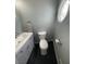 Small bathroom features updated vanity with countertop sink, toilet, and distinctive octagonal window at 6171 Whispering Sands Dr, Las Vegas, NV 89131