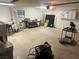 Large garage with ample space for parking and storage, equipped with work tables and tools at 6171 Whispering Sands Dr, Las Vegas, NV 89131