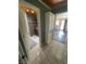 Hallway with tiled floors leads to a bathroom and other rooms, offering a clean aesthetic at 6171 Whispering Sands Dr, Las Vegas, NV 89131