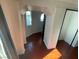 Hallway featuring unique architectural archway and beautiful wood floors at 6171 Whispering Sands Dr, Las Vegas, NV 89131