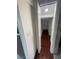 Hallway with hardwood floors leading to what looks like a storage area at 6171 Whispering Sands Dr, Las Vegas, NV 89131