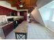 Bright kitchen featuring a breakfast bar, stainless steel appliances, and wood-beamed ceiling at 6171 Whispering Sands Dr, Las Vegas, NV 89131