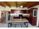 Modern kitchen with stainless steel appliances, granite countertops, and wood ceiling at 6171 Whispering Sands Dr, Las Vegas, NV 89131