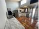 Bright kitchen with granite countertops, white cabinets, stainless steel refrigerator, and tile flooring at 6171 Whispering Sands Dr, Las Vegas, NV 89131