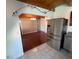Open-concept kitchen boasts stainless steel appliances and hardwood flooring at 6171 Whispering Sands Dr, Las Vegas, NV 89131